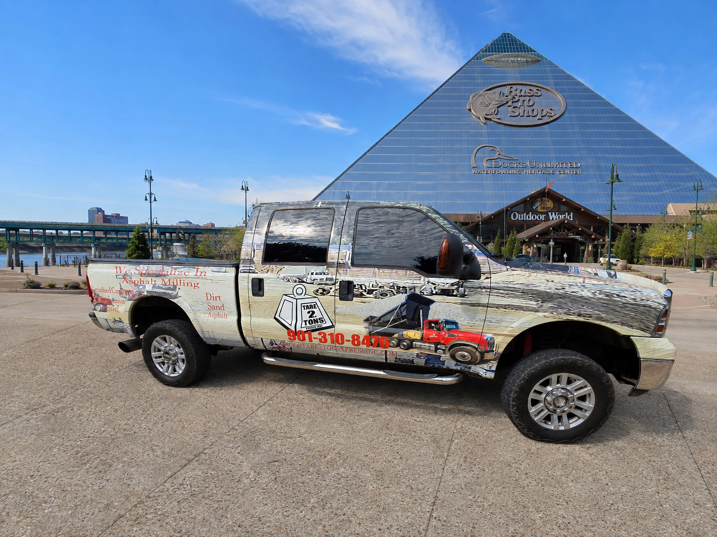 Chrome-wrapped Tare 2 Tons Xpress advertising pickup at the Memphis Pyramid