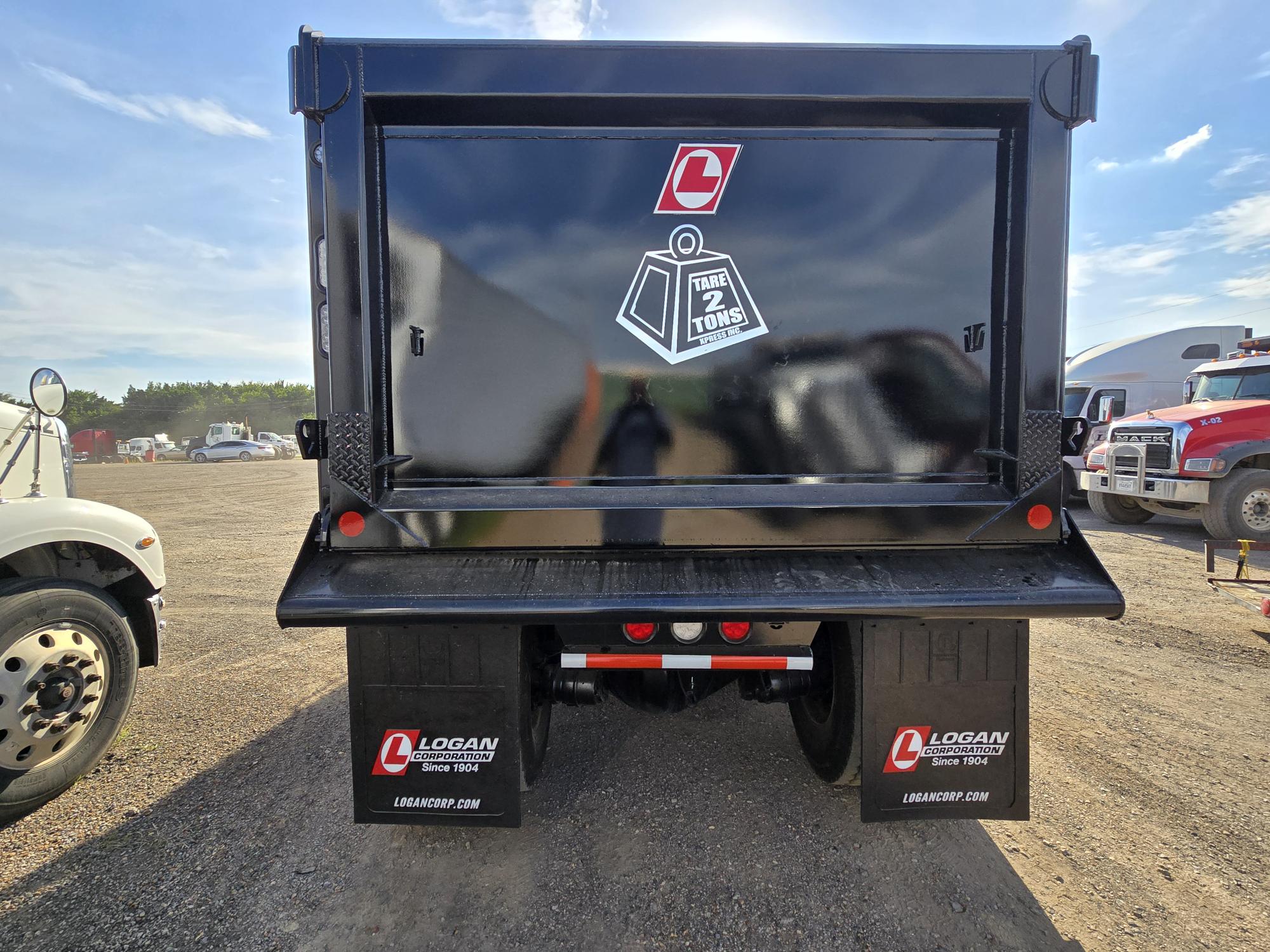 Rear view of a Tare 2 Tons Xpress dump truck showing the company logo